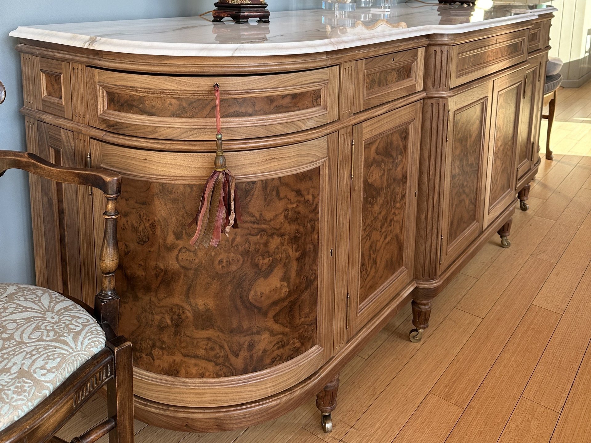 Louis XIV sideboard in walnut and walnut burl with a shaped marble top and turned legs on castors