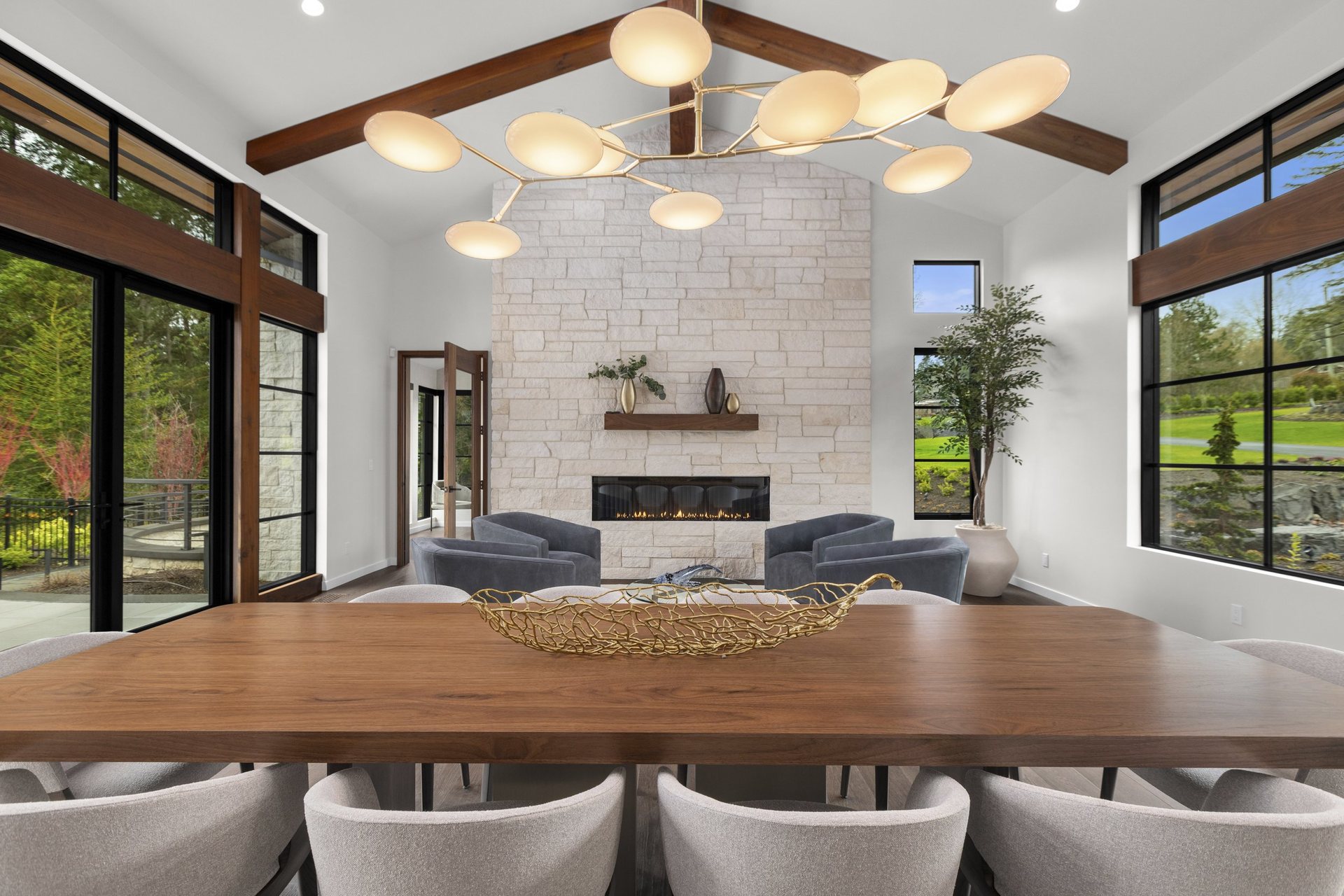 Walnut Ridge Residence dining room with a live-edge walnut table beneath a vaulted beamed ceiling