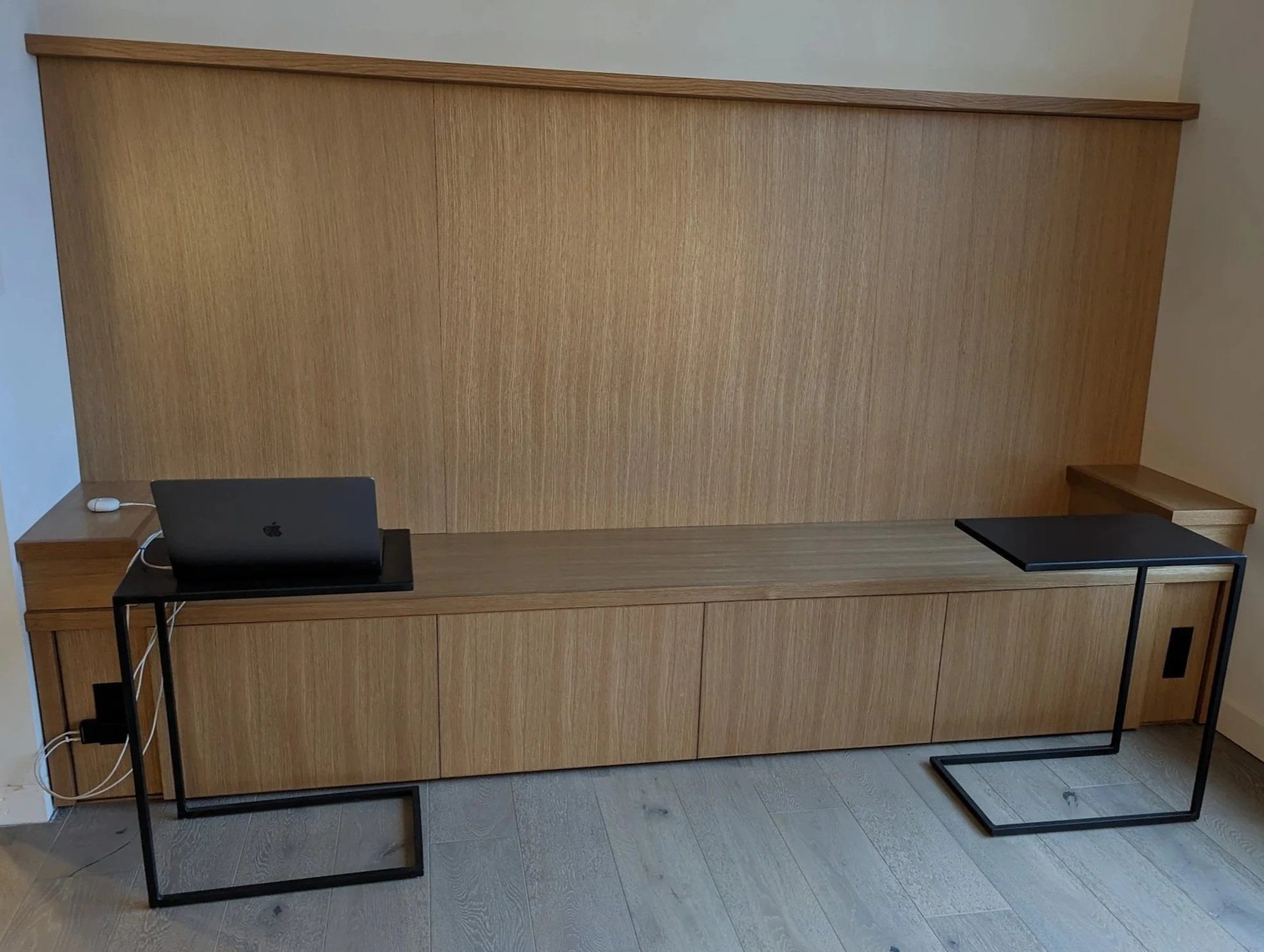Rift-cut white oak built-in bench with concealed drawer storage against a matching panelled wall